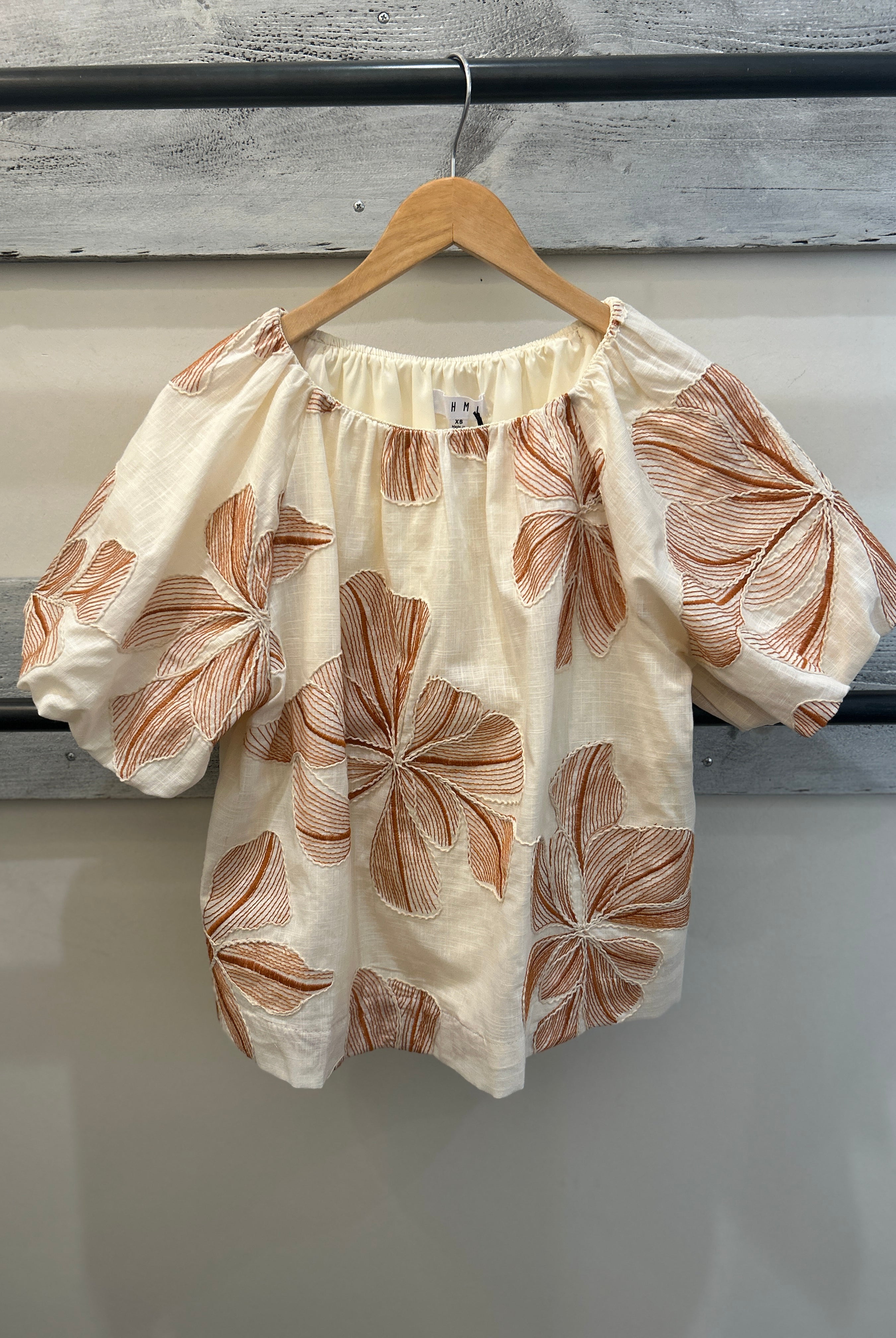 beige top with brown floral pattern