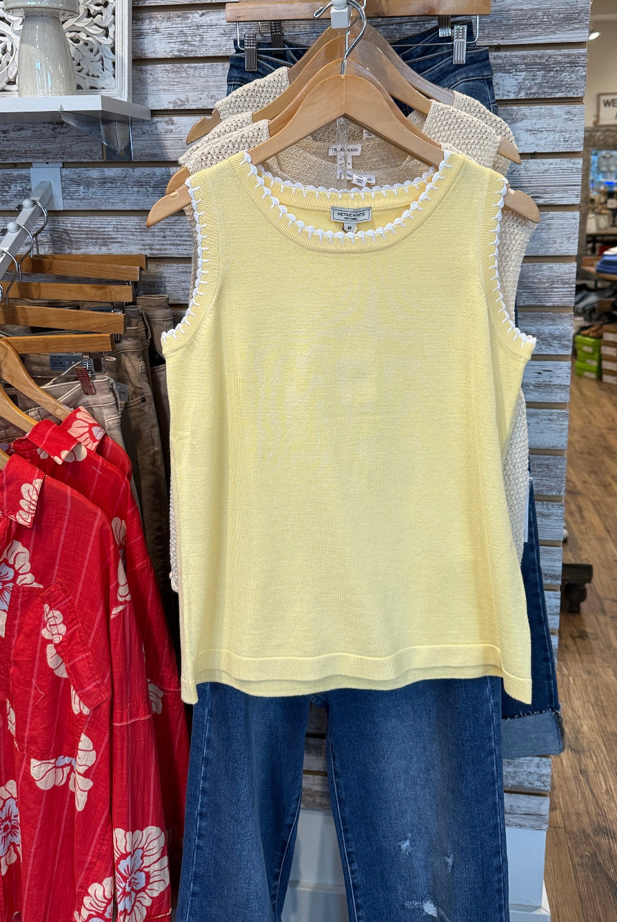 Sleeveless yellow top with white scalloped detail