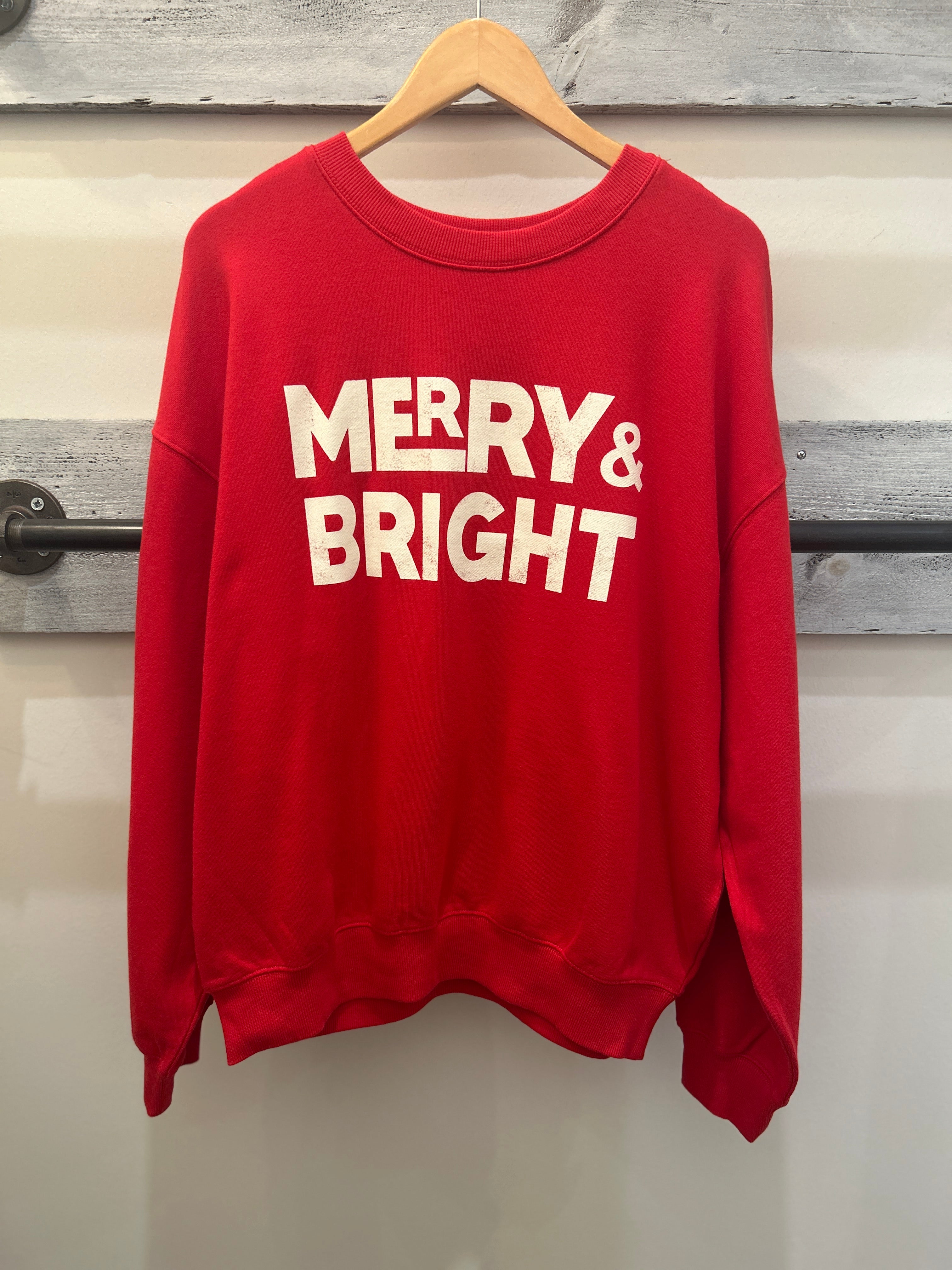 Red sweatshirt with off-white 'Merry & Bright' graphic for Christmas holiday.