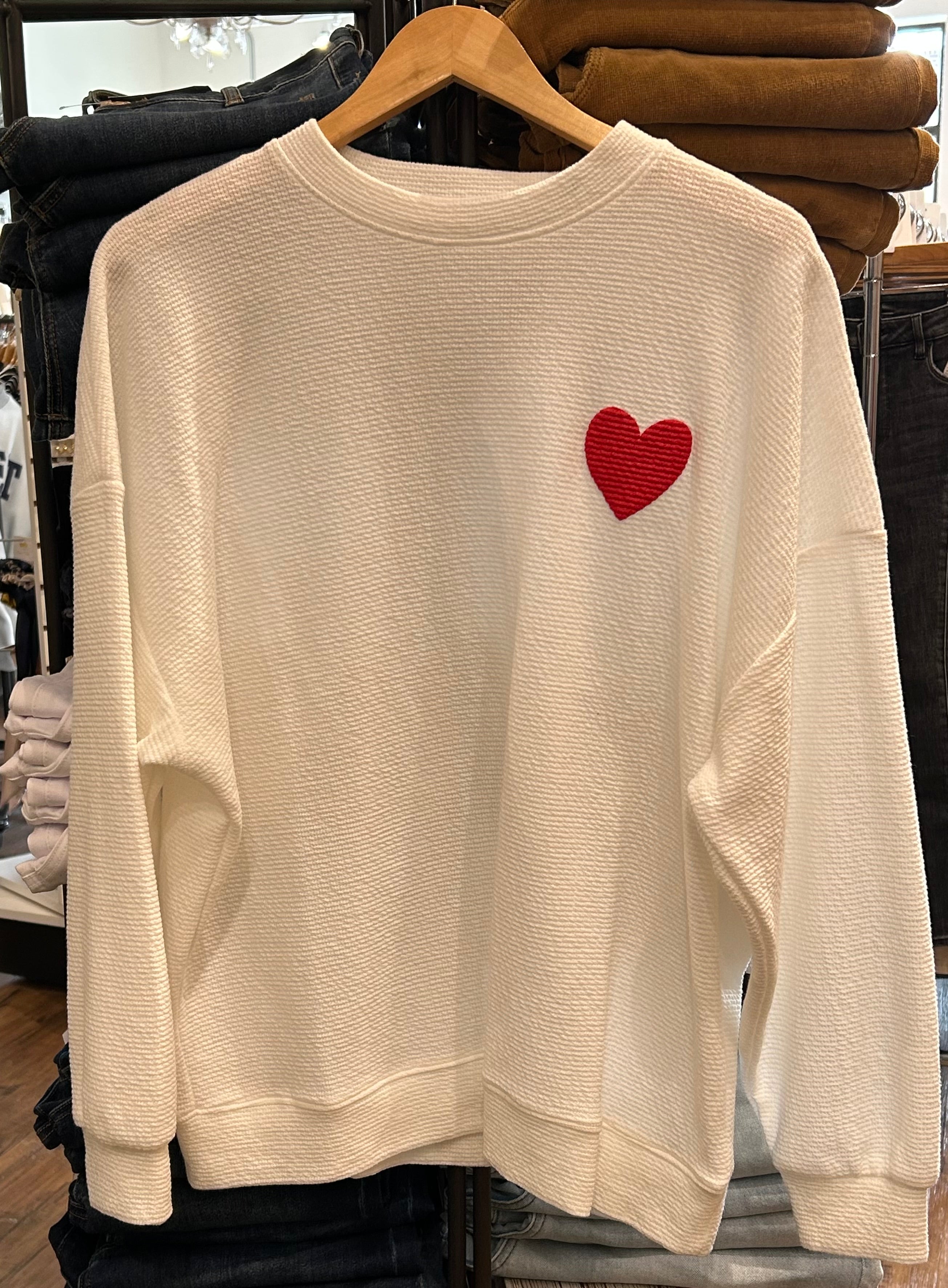 Cream sweatshirt with red heart graphic