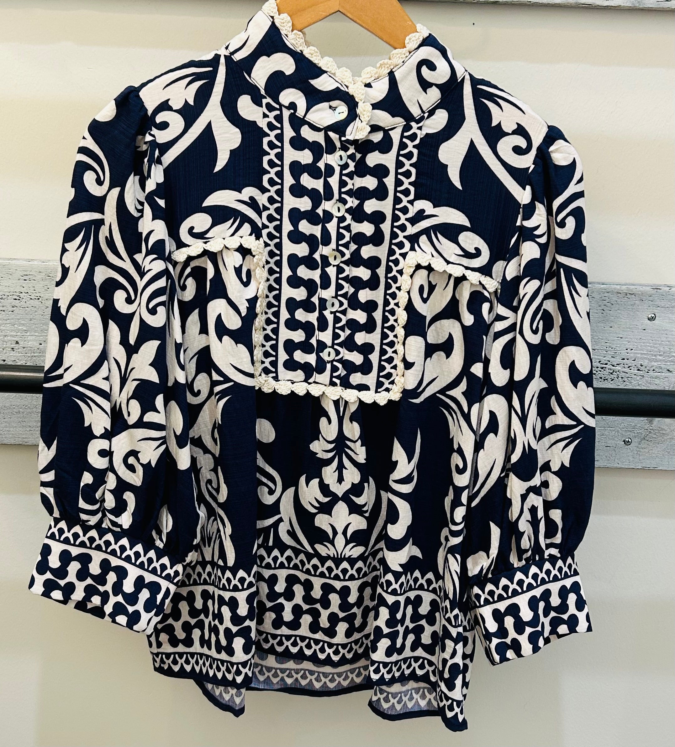 Navy blue and white patterned blouse