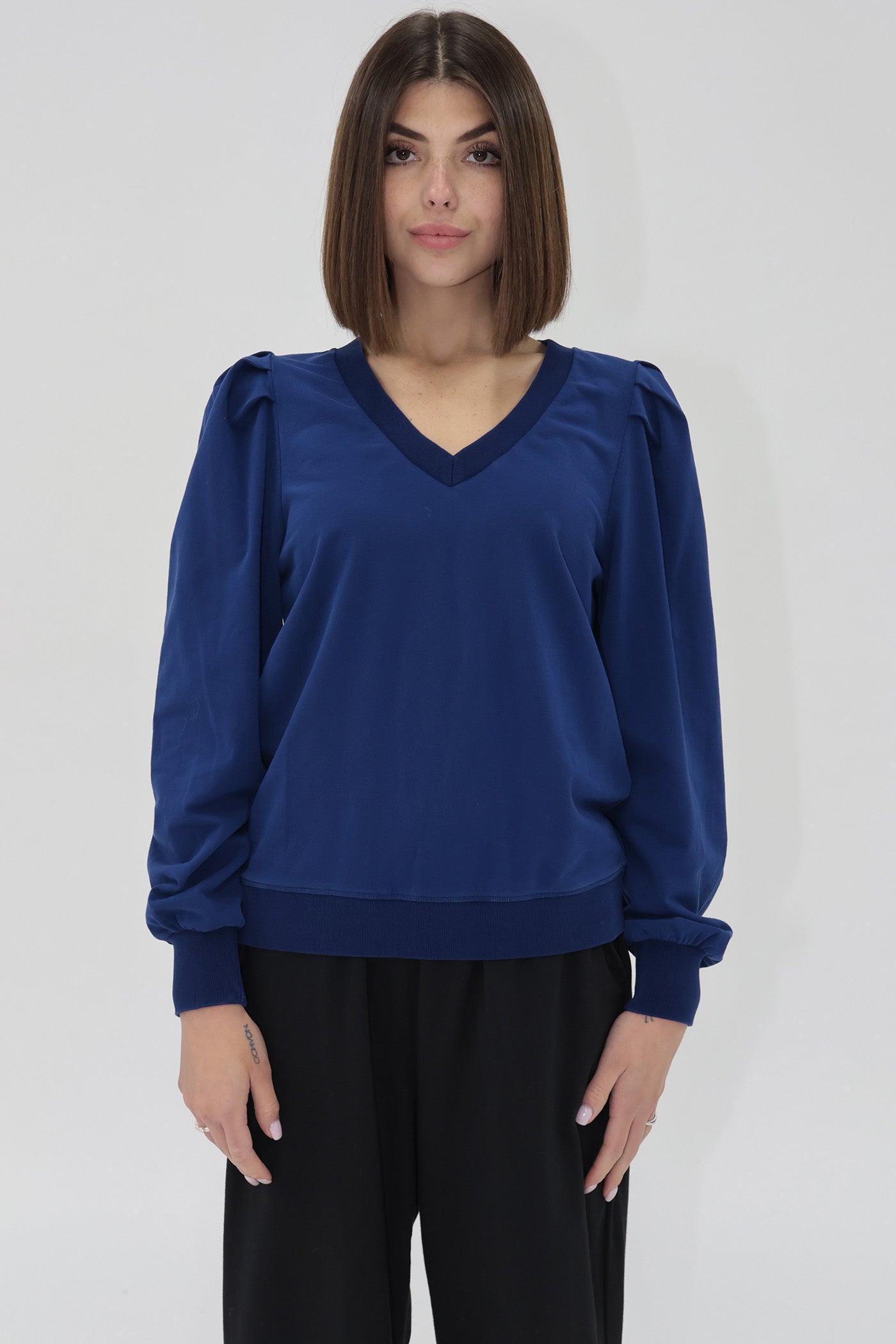 Another Love blue long sleeve sweatshirt with v-neck, slight puff sleeve detail, ribbed cuffs.