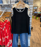 Black sleeveless Top with Scalloped white trim.