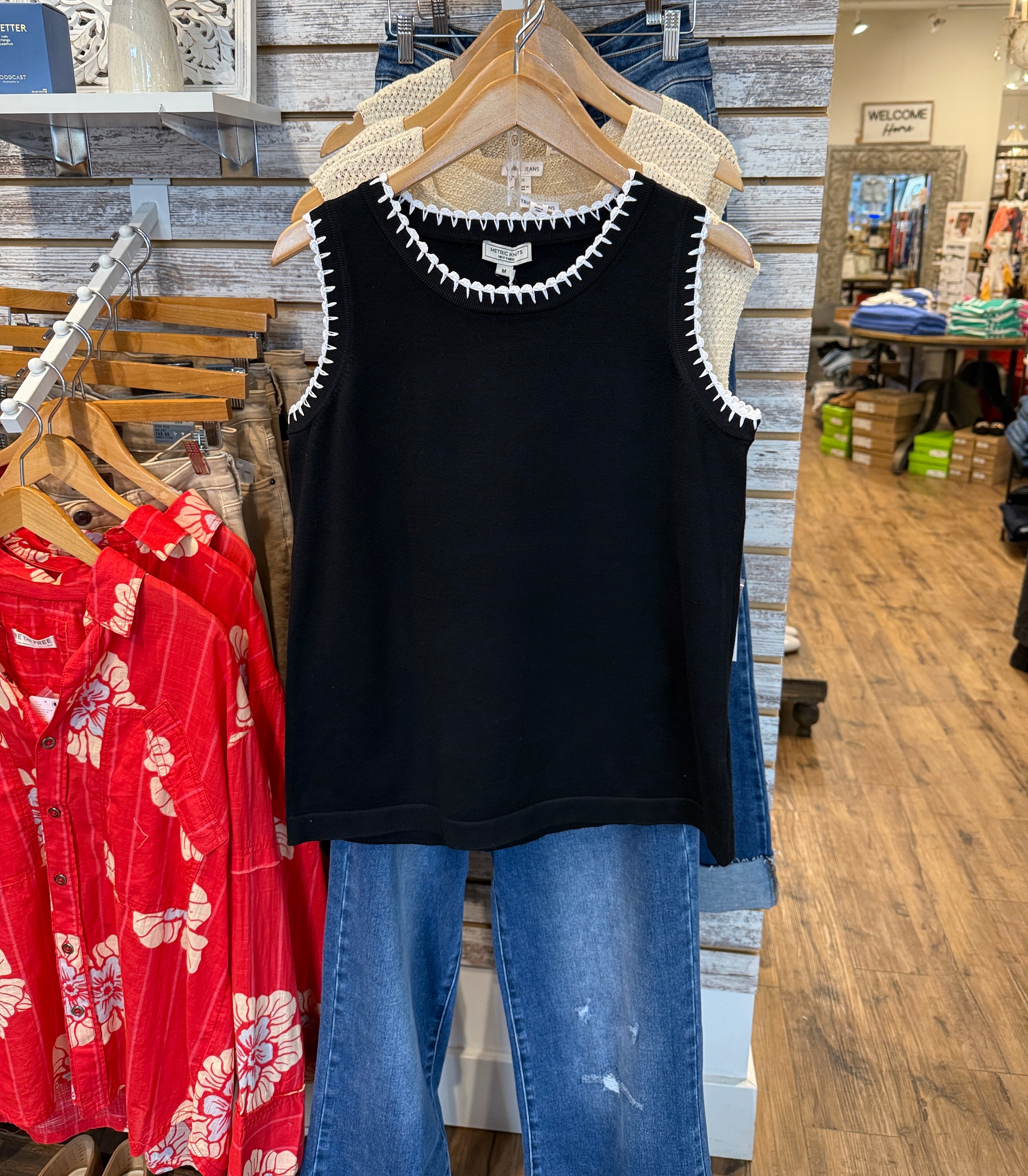 Black sleeveless Top with Scalloped white trim.