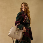 HOBO medium beige satchel bag with gold accents.