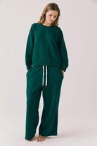 Woman wearing  green sweat pants 