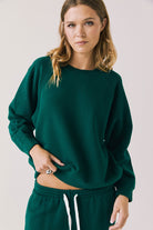 Woman wearing a green sweatshirt 
