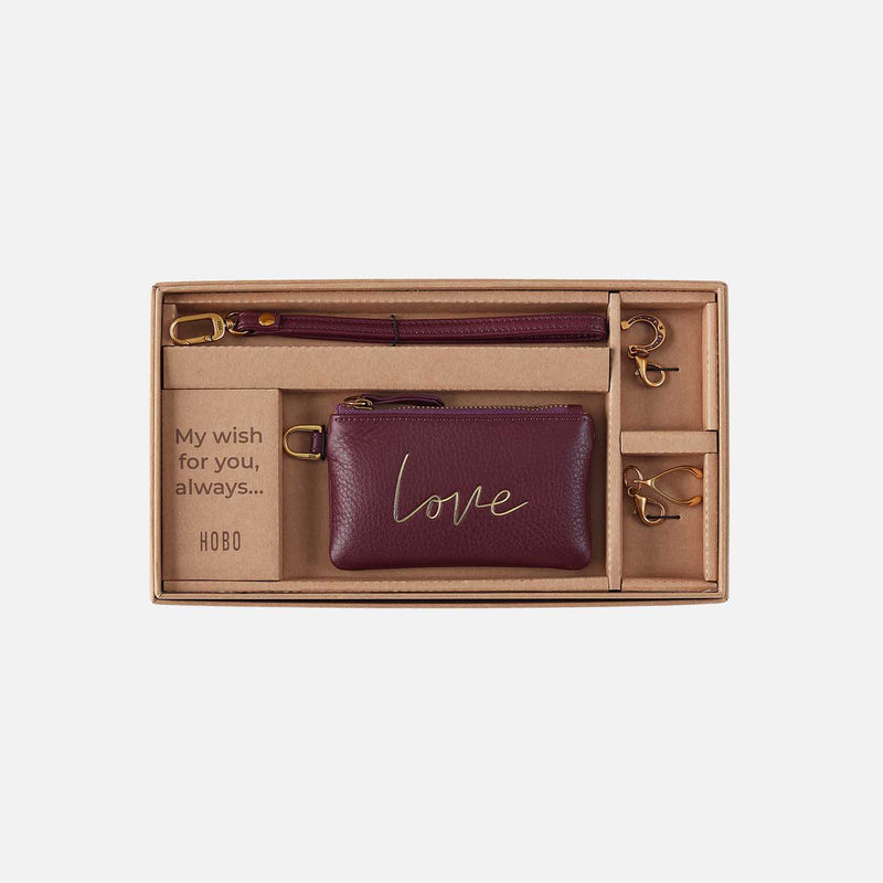 Maroon wallet with 'love' engraving in a gift box