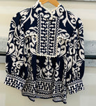 Navy blue and white patterned blouse 