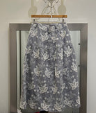Tiered skirt with floral embroidery over black gingham fabric