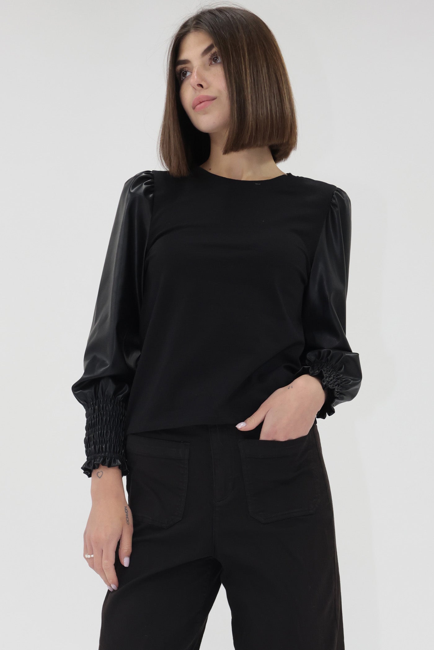 Another Love black long sleeve crewneck top with vegan leather sleeves and ruched cuffs