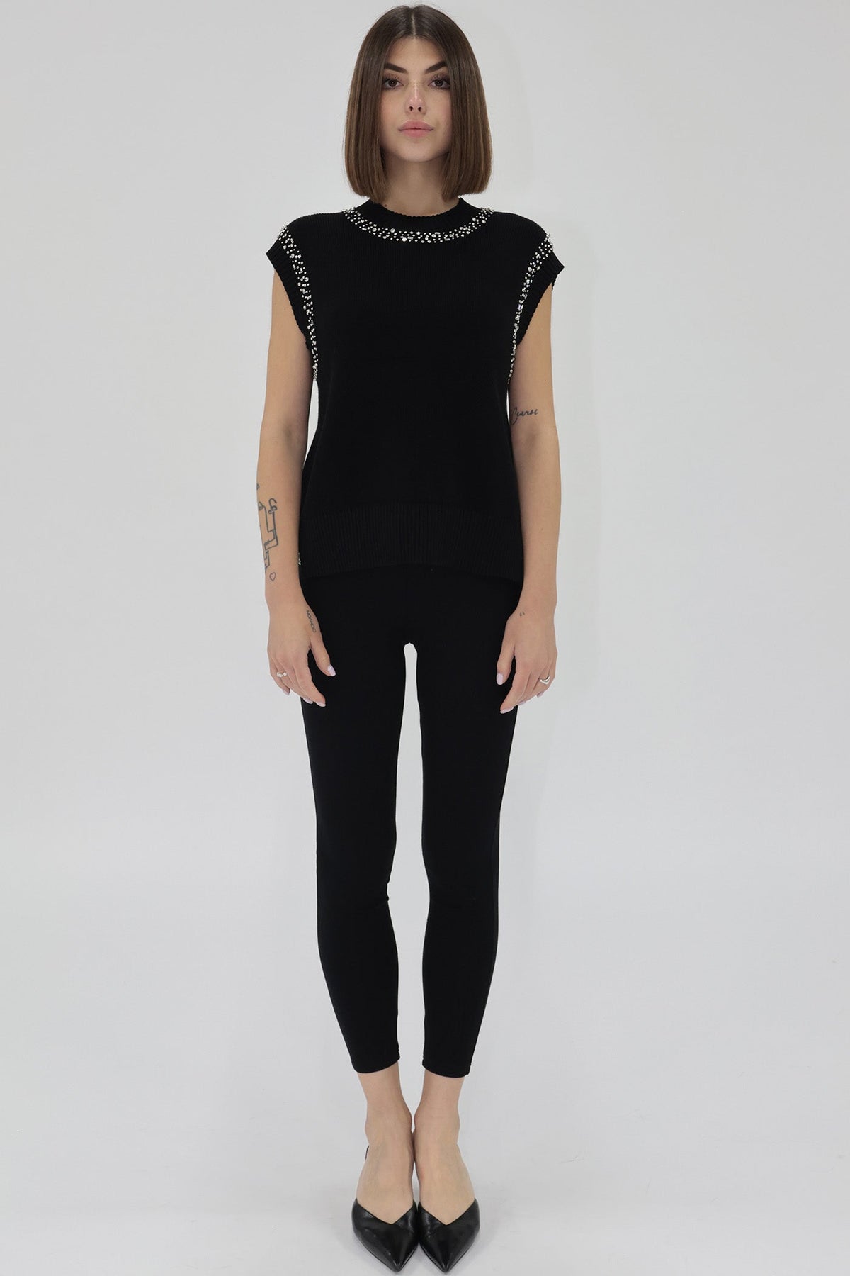 Woman Wearing Sleeveless Black Sweater with Embellishment detail