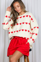 Cream long sleeve sweater with red heart pattern