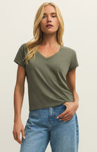 Woman wearing an olive green V-neck t-shirt 