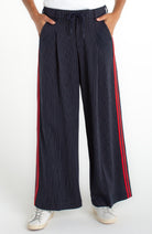 Navy pleated pants with red stripes 