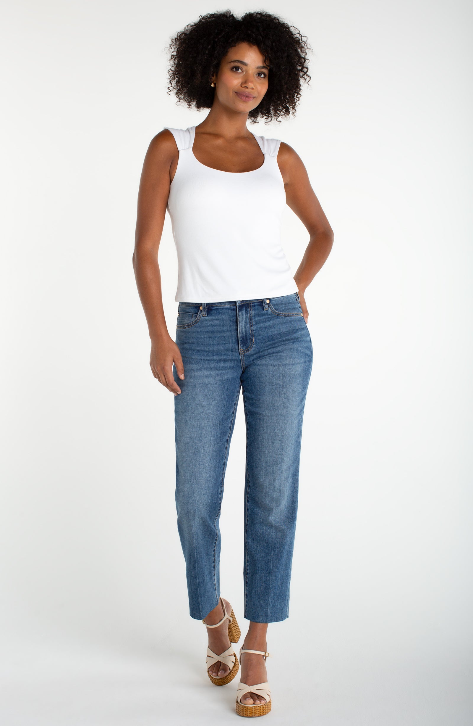 Liverpool white tank with built-in bra with wide straps. Sleek, supportive, and ready for anything—this Liverpool knit top features a built-in bra for all-day comfort without the extra layers. The sleeveless silhouette keeps things cool and versatile, perfect for layering or wearing solo. Crafted from quality knit fabric, it's a wardrobe essential that works as hard as you do. Pair it with your favorite jeans, skirts, or under sheer pieces for endless styling possibilities.