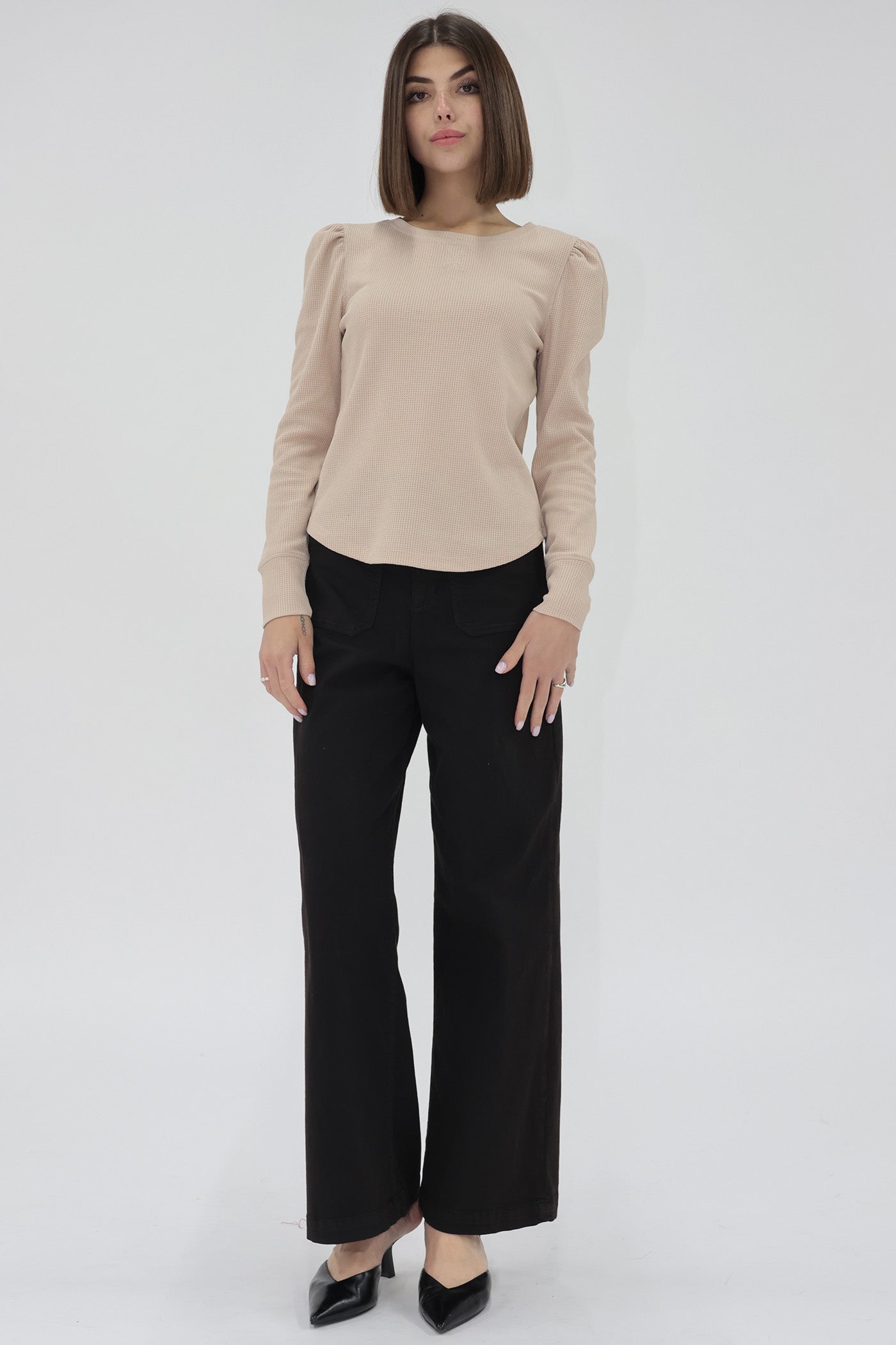 Woman wearing a beige long sleeve sweater