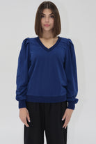 Another Love blue long sleeve sweatshirt with v-neck, slight puff sleeve detail, ribbed cuffs.